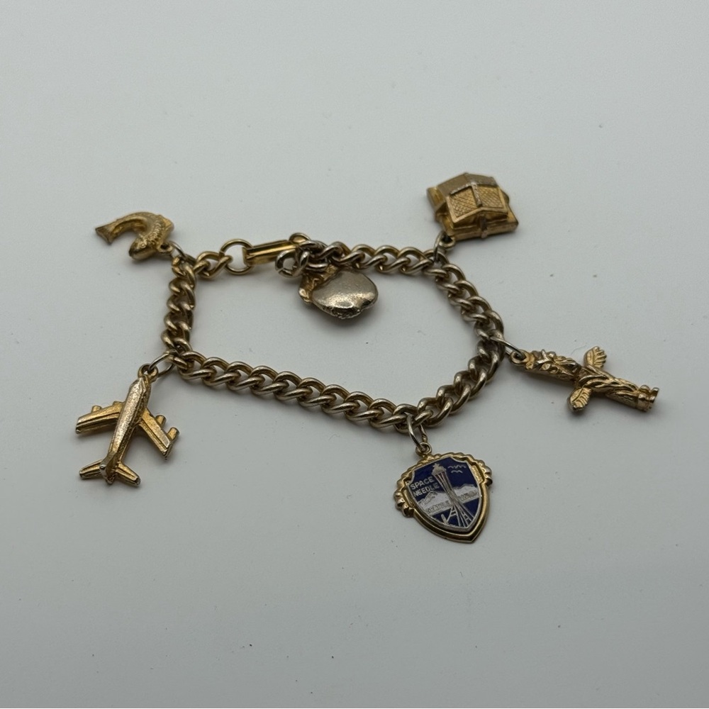 Gold tone Charm Bracelet with Airplane and fish Charms